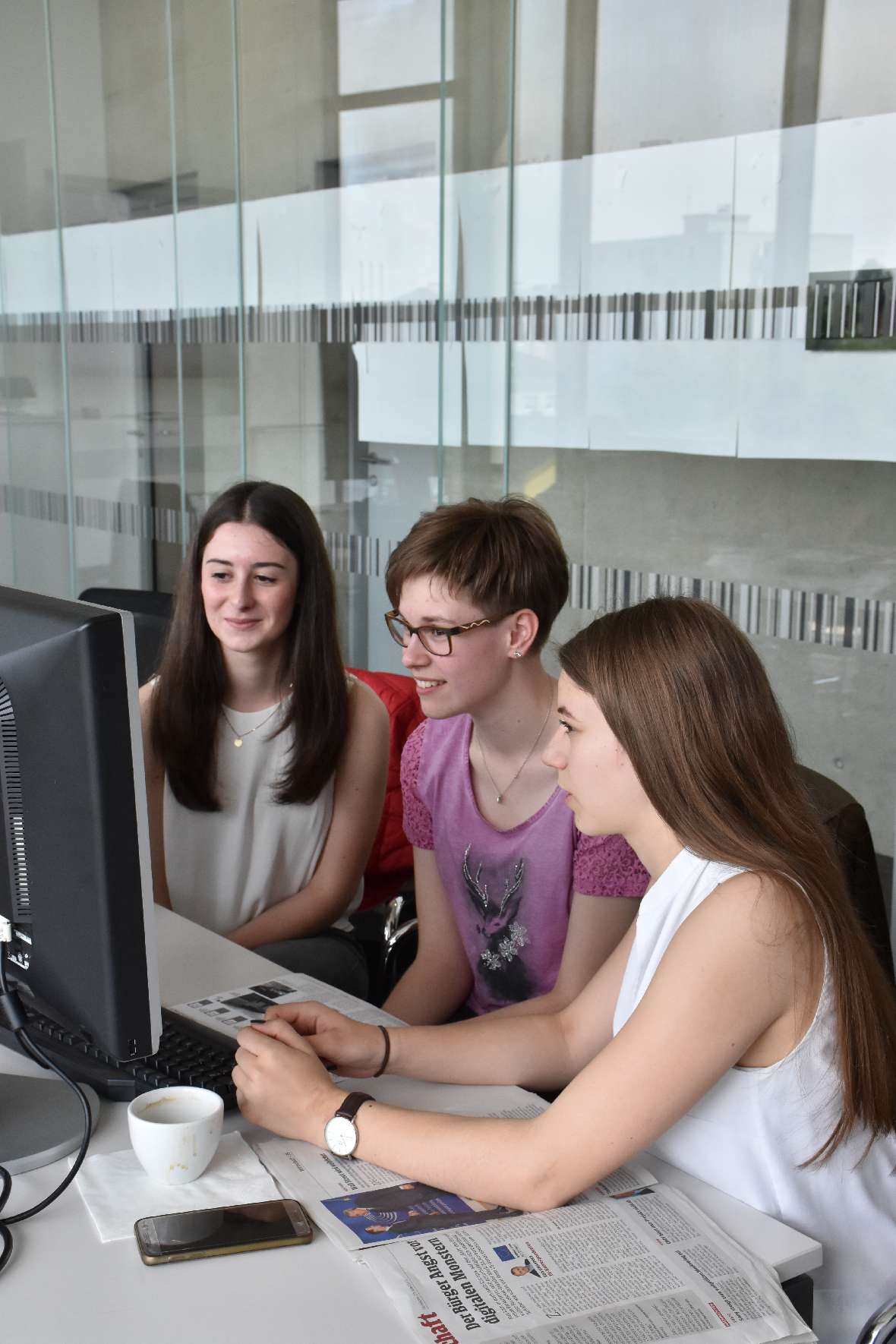 Kleingruppe von Schülerinnen am Computer